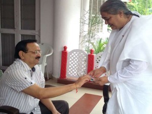 B.K. Shailja after Tying Rakhi to give a blessing card to District Judge Bharat Bhushan Shrivastava